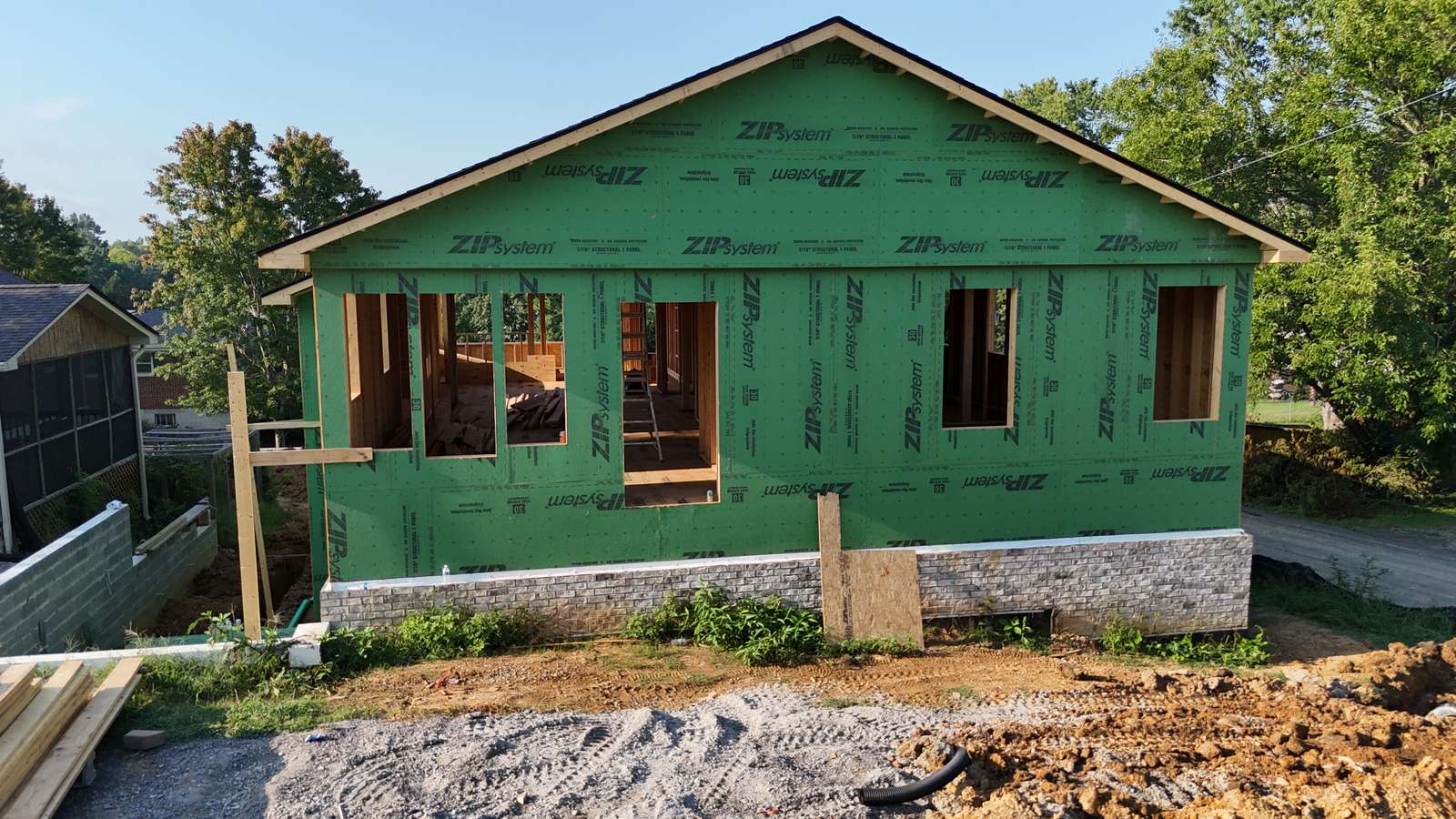 Single-story ZIP-sheathed addition or new volume in framing.