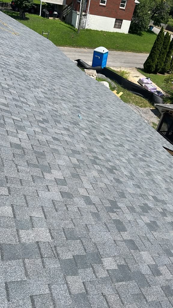 Architectural shingle roof looking toward a construction lot.