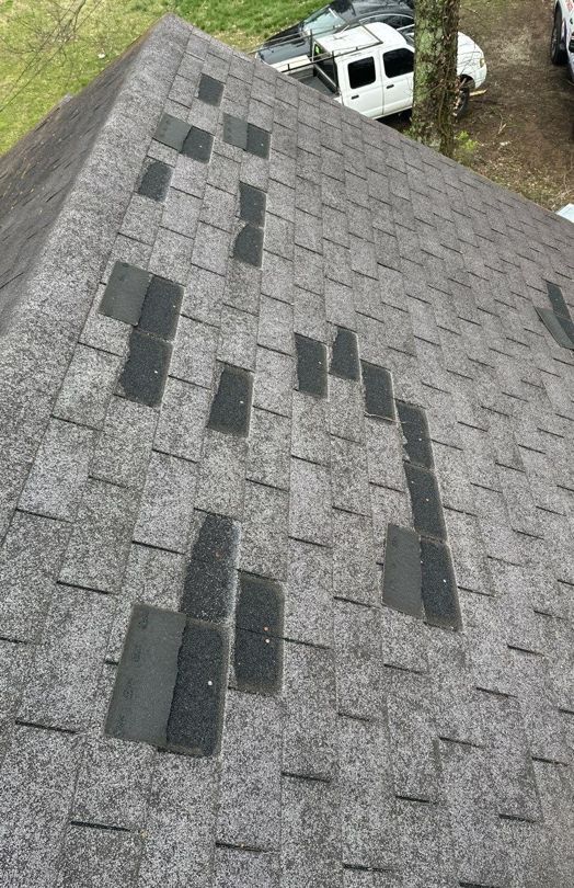 Shingles torn off by wind on a roof, private residence, Middle Tennessee