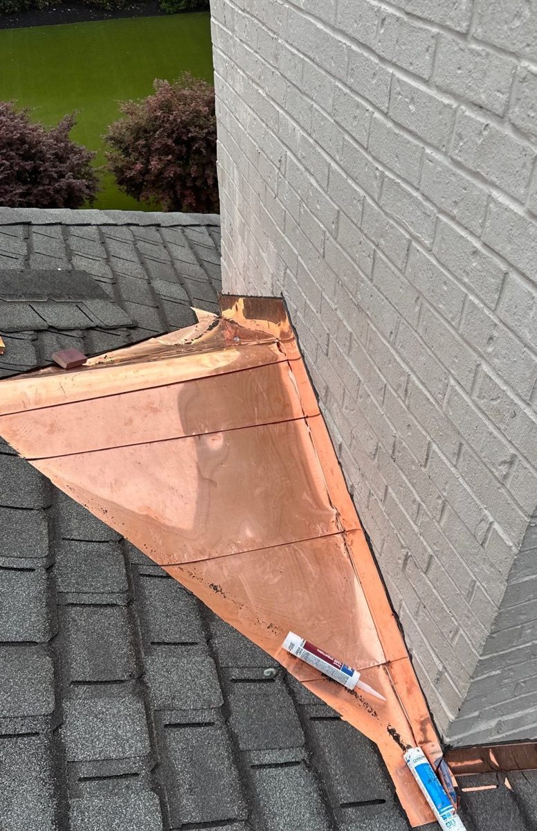 Copper cricket and flashing behind a painted brick chimney, private residence, Middle Tennessee
