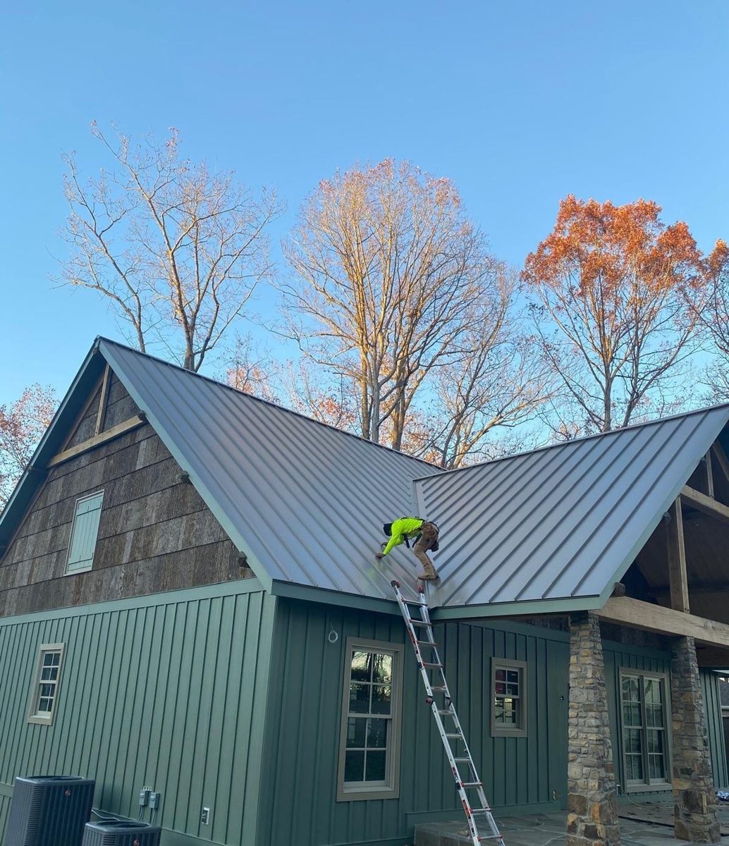 Tan standing seam metal roof on a stone and board-and-batten home, Middle Tennessee