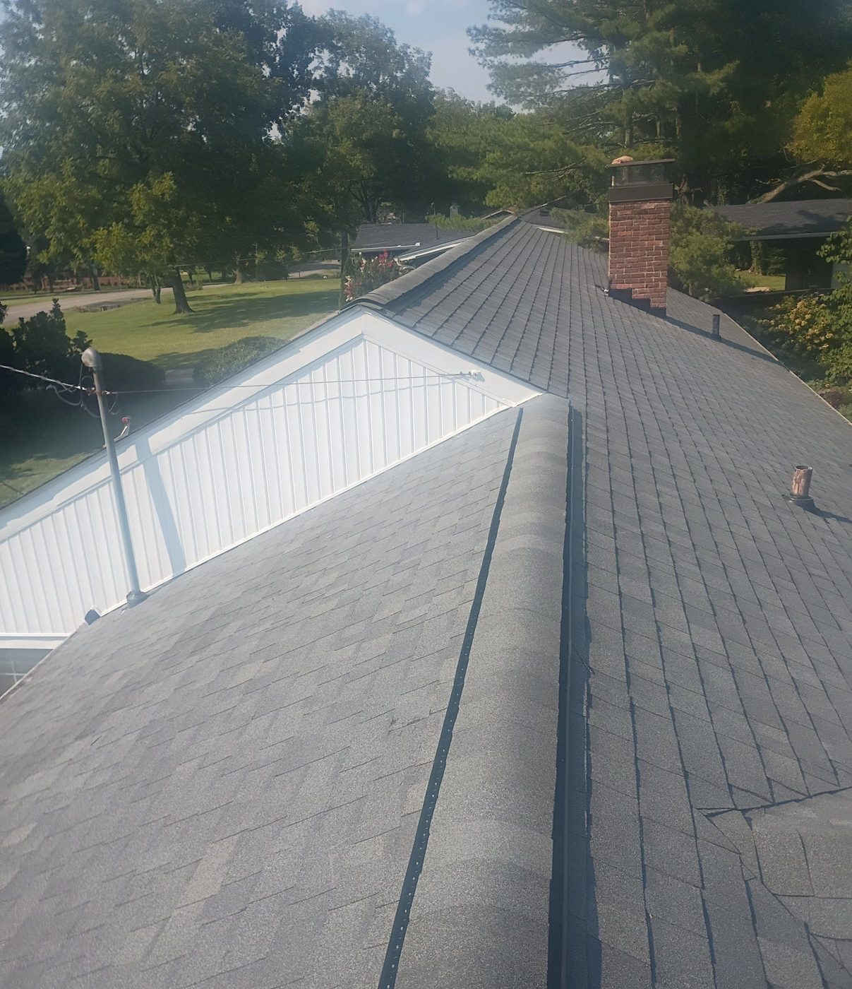 New shingle roof ridge and rebuilt chimney flashing, private residence, Middle Tennessee